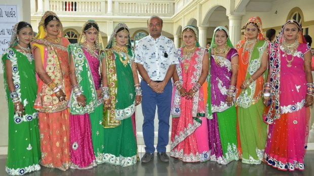 Savani with brides last year at his Surat school where the mass weddings take place.