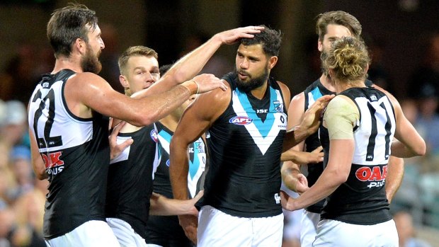 Paddy Ryder celebrates a goal with his Port Adelaide teammates.