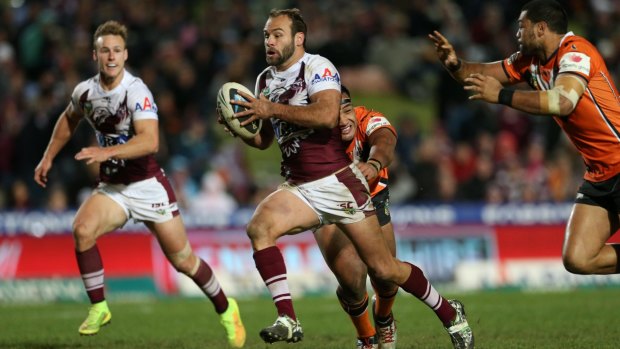 Brett Stewart makes a break for the Manly Sea Eagles against Wests Tigers in 2014.