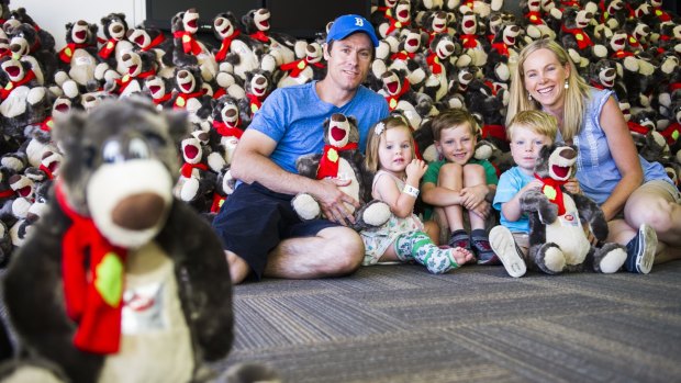 The Davidson family, Brad, Zara (2), Cooper (5), Finn (2) and Megan of Harrison with some of the teddy bears to be given to children at the Canberra Special Children's Christmas Party at Thoroughbred Park on Sunday.
