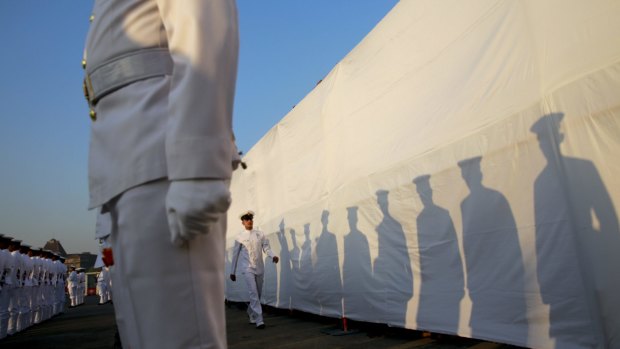 Indian Navy personnel attend a ceremony for the warship Godavari at the dockyard in Mumbai.