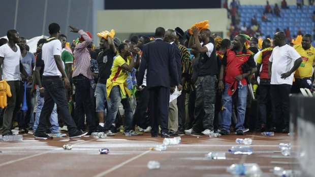 Sad sight: Ghana supporters react after the were attacked by Equatorial Guinea fans.
