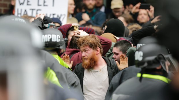 Protesters are isolated by police following the deployment of pepper spray in downtown Washington.