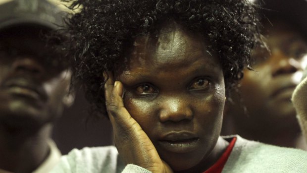 A woman waits for her son, who was rescued from Garissa University.