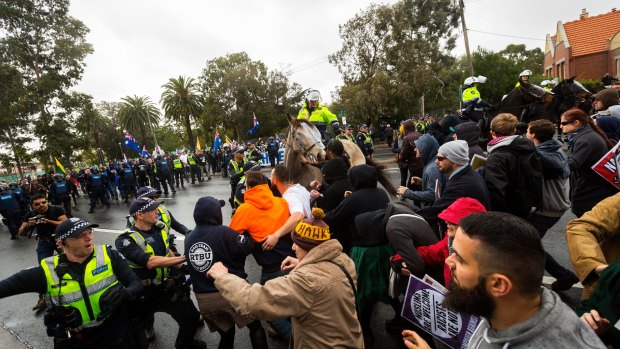 Police hold back members of the 'Say no to Racism' group who were protesting an anti-Islam rally organised by the True Blue Crew and backed by the United Patriots Front. 