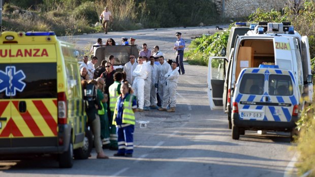 An ambulance is parked along the road where a car bomb exploded killing investigative journalist Daphne Caruana Galizia, in the town of Mosta, Malta.