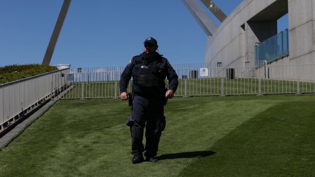 A security guard patrols the lawns at Parliament House.