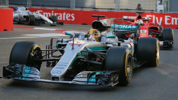 Fuel to the fire: Lewis Hamilton of Mercedes, with Ferrari driver Sebastian Vettel in tow - who appeared to intentionally swerve into the former after running into the back of him.