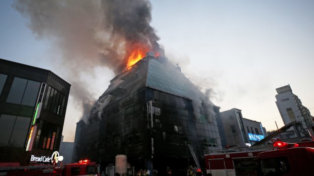 Smoke rises as firefighters try to extinguish a fire at an eight-floor building in Jecheon, South Korea, last week.