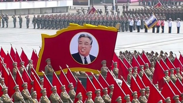A portrait of the country's founder Kim Il-sung is carried during a parade in Pyongyang on Saturday.