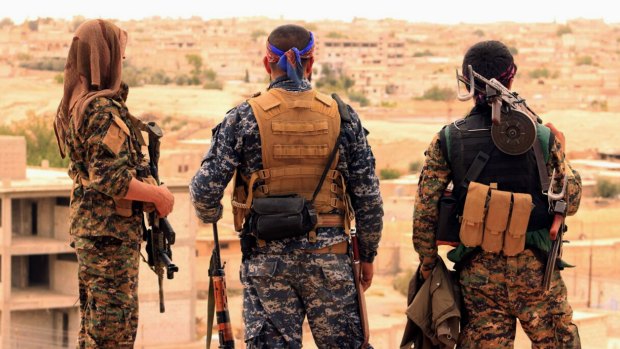 Fighters from the US-backed Syrian Democratic Forces looking towards the town of Tabqa, Syria. 
