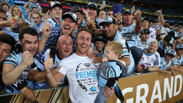 Champ: Maloney celebrates a premiership with the Sharks last year.