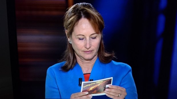 French Environment Minister Segolene Royal reading the Environment Victoria postcard calling for Hazelwood to be shut.