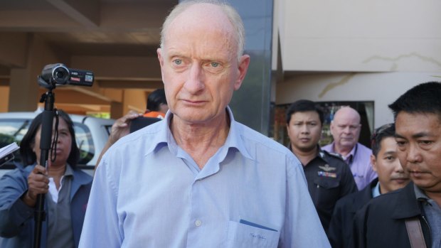 Peter Dundas Walbran with police after his arrest in Ubon Ratchathani, Thailand on December 9.  