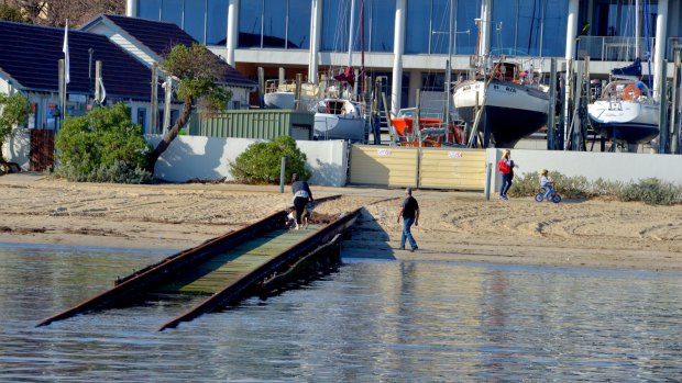 A fight has broken out at Royal Brighton Yacht Club's over its unusable boat ramp, which has left six yachts stranded inside repair yards there. 