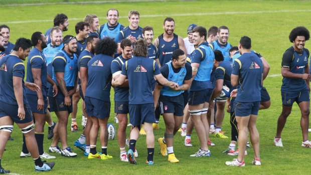 Guest Wallaby: Krisnan Inu, centre, laughs during a training session with the Wallabies in Paris.