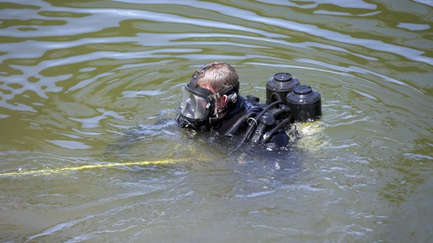 A police diver in the Maribynong River.