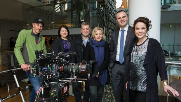 (From left) Director of photography Bruce Young, Screen ACT Director Monica Penders, director Shawn Seet, <i> The Code</i> writer Shelley Birse, Chief Minister Andrew Barr, and actress Sigrid Thornton on set on Tuesday.