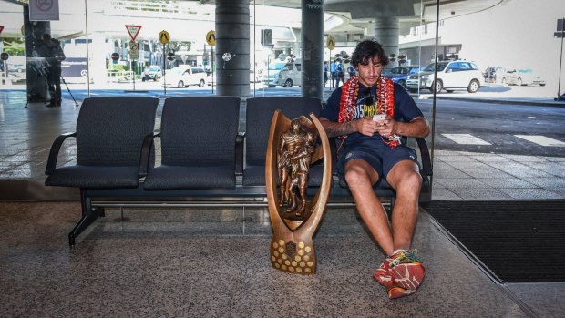 Excess baggage: Johnathan Thurston with the NRL trophy the day afther the grand final win over Brisbane.
