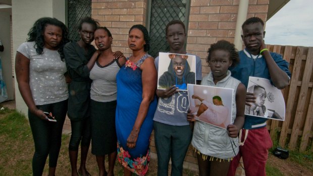 Mourning his death: Peter Maketh's mother Martha Atem, third from left, and siblings Elijah, Anok, and Thon, holding photos of their older brother.