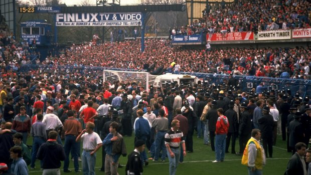 Tragedy: Supporters are crushed against the barrier at Hillsborough Stadium.