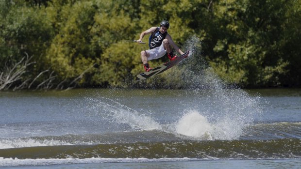 Leigh Baguley of Lyneham, cools off on Sunday, enjoying a run on his wakeboard, in the Molonglo River. 
