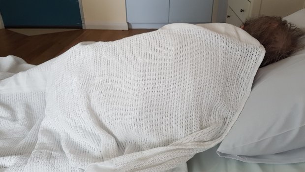 The grandmother after her hospital visit. She refused to get out of bed. A month later, it is still difficult to convince her to get up in the morning. 