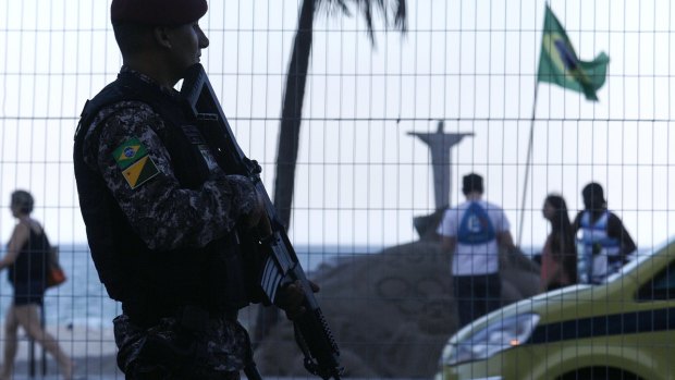All eyes on Rio: A Brazilian National Force soldier keeps watch along Copacabana beach.