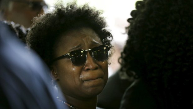 A family member weeps while entering the church for the funeral of Walter Scott.