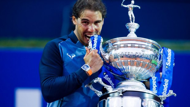 On his game: Rafael Nadal poses with the trophy after defeating Kei Nishikori at the Barcelona Open.