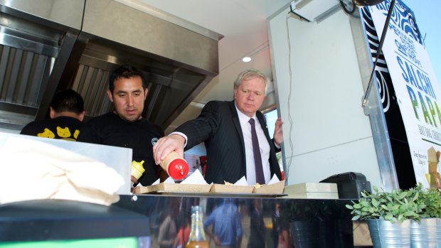 ANU Vice-Chancellor Brian Schmidt serves food at Mr Papa.