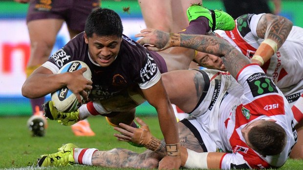 Over he goes: Anthony Milford of the Broncos scores a try against the Dragons.