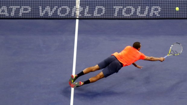 Jo-Wilfried Tsonga dives to return the ball to Rafael Nadal.