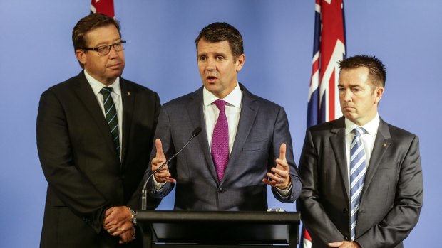 The greyhound ban is weighing heavily on Deputy Premier Troy Grant, left, and Premier Mike Baird. 