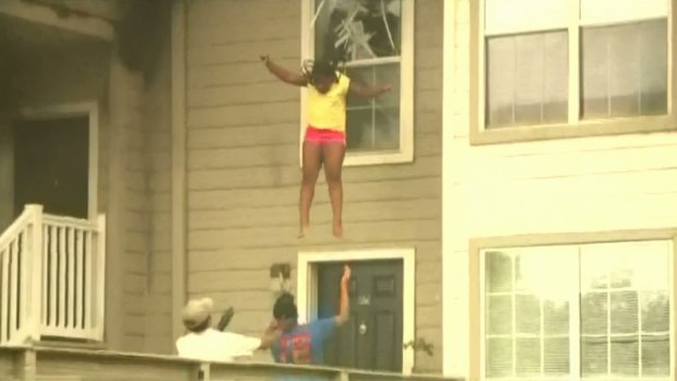 Two sisters leap for their lives from the window of a burning apartment building.