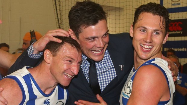 Ready for anything: North Melbourne's Ben Jacobs with Brent Harvey and Nathan Grima after the win against Richmond. 