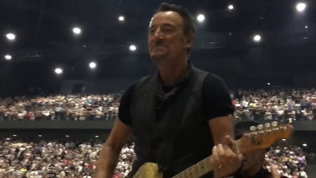 Bruce Springsteen leads his bandmates through the crowd in a conga line during a power outage at AccorHotels Arena in Paris on Monday.