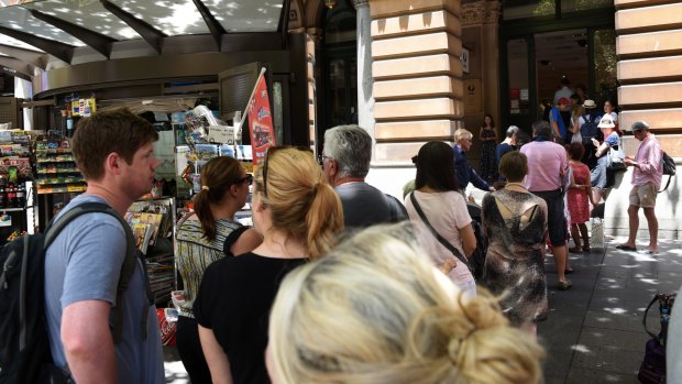 Customers, many seeking passport services, line up at Martin Place post office on Wednesday. 