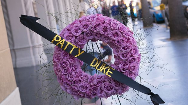 Flowers are placed on The Hollywood Walk Of Fame Star Of Patty Duke.