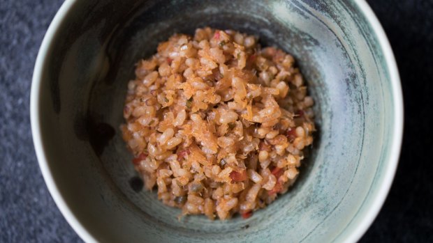 Go-to dish: Sofrito rice over house-aged wild barramundi.