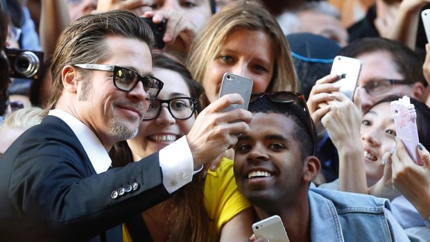 Brad Pitt takes time for selfies with fans. 