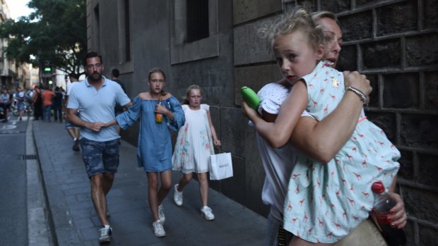 People flee the scene in Barcelona, Spain.