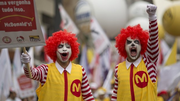 Two demonstrators dressed as Ronald McDonald protest for better wages for McDonald's employees in Sao Paulo, Brazil.