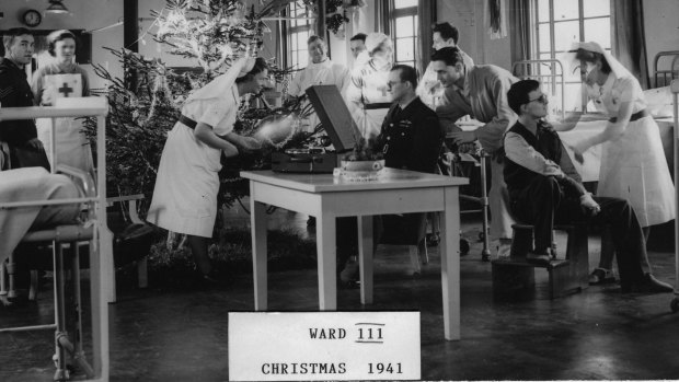 So this is Christmas: Nurses and patients in 1941 in Ward III at Queen Victoria Hospital, East Grimstead.