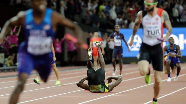 Shot down: Jamaica's Usain Bolt drops the baton as he pulls up injured in the final of the Men's 4x100m relay during the World Athletics Championships.