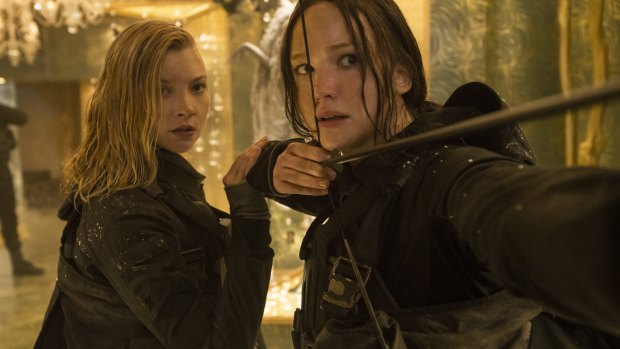 Katniss Everdeen (Jennifer Lawrence) tries to protect her younger sister younger sister (Willow Shields) in <i>The Hunger Games: Mockingjay Part 2</i>.