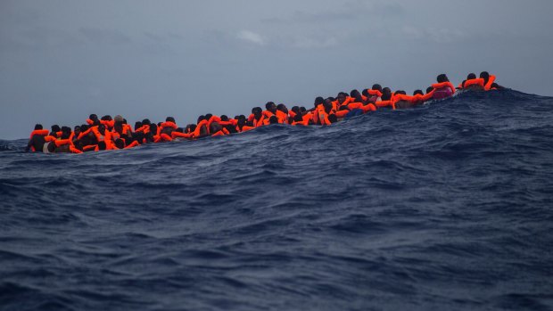 Sub-saharan migrants wait to be rescued in the Mediterranean Sea. 