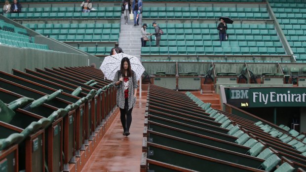 On hold: The action at Roland Garros was suspended on Monday due to heavy downpours.