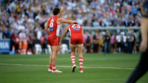 Painful: Sydney's key forwards, Kurt Tippett and Buddy Franklin, commiserate after their grand final loss.