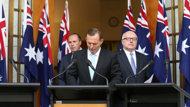 Prime Minister Tony Abbott with Immigration Minister Peter Dutton and Attorney-General George Brandis during a joint press conference at Parliament House on Tuesday. 